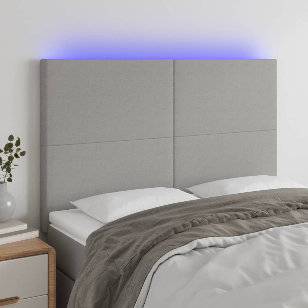 sengegavl med LED-lys 144x5x118/128 cm stof lysegrå