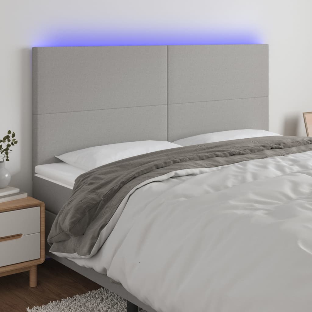 sengegavl med LED-lys 160x5x118/128 cm stof lysegrå
