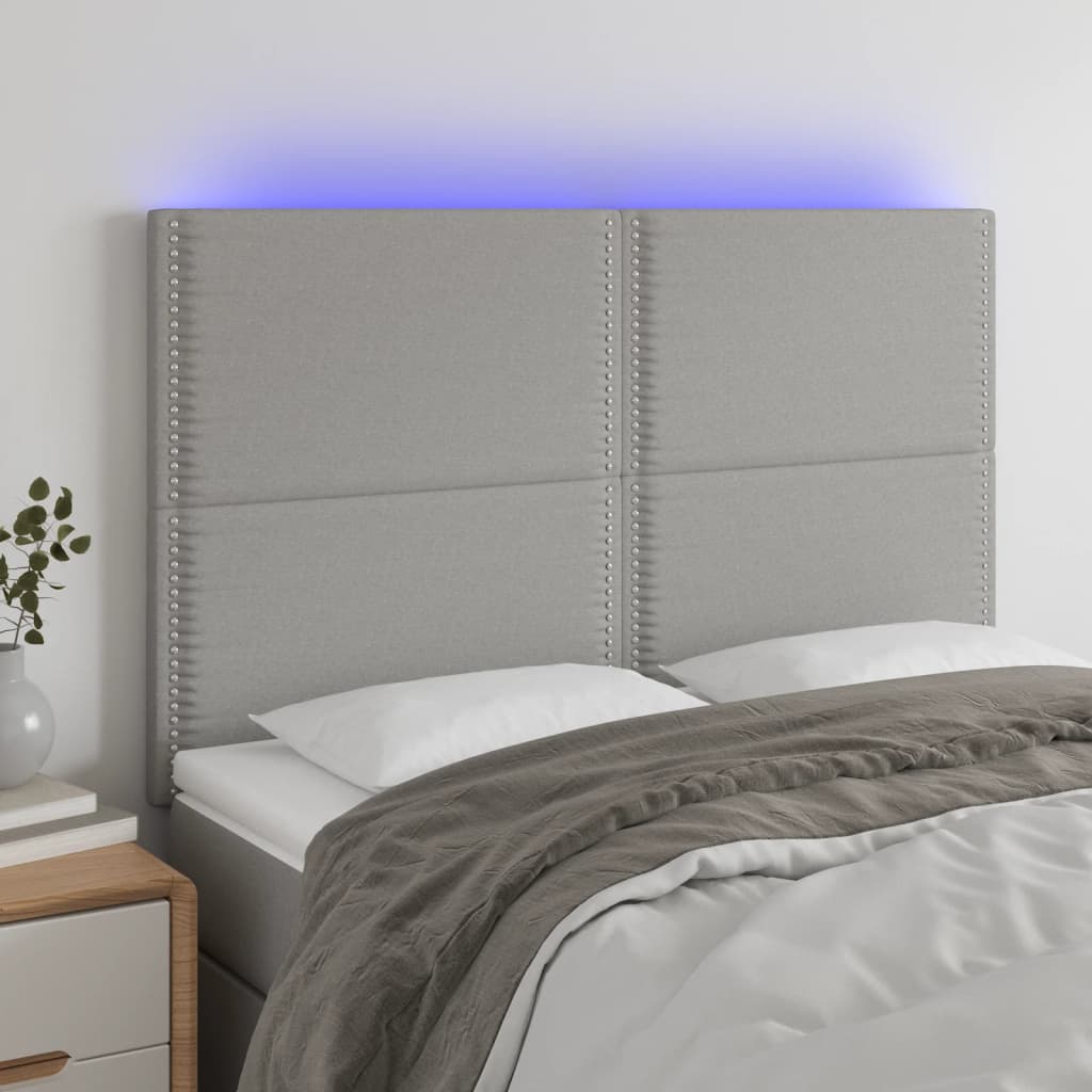 sengegavl med LED-lys 144x5x118/128 cm stof lysegrå