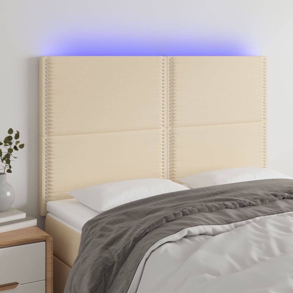 sengegavl med LED-lys 144x5x118/128 cm stof cremefarvet