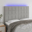 sengegavl med LED-lys 144x5x118/128 cm stof lysegrå