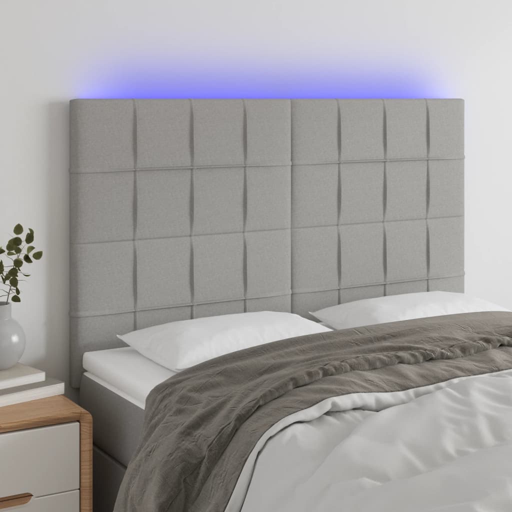 sengegavl med LED-lys 144x5x118/128 cm stof lysegrå