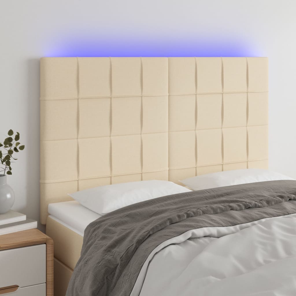 sengegavl med LED-lys 144x5x118/128 cm stof cremefarvet
