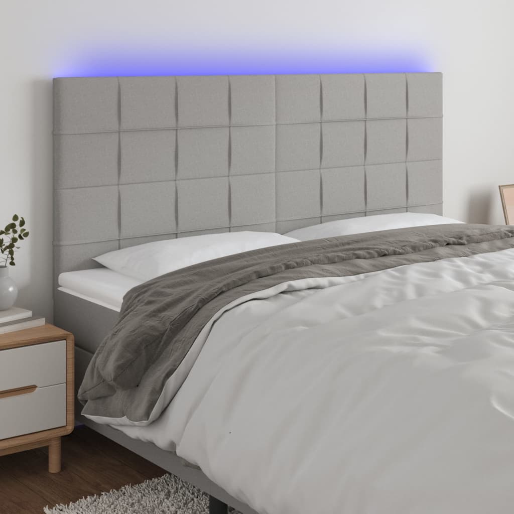 sengegavl med LED-lys 160x5x118/128 cm stof lysegrå