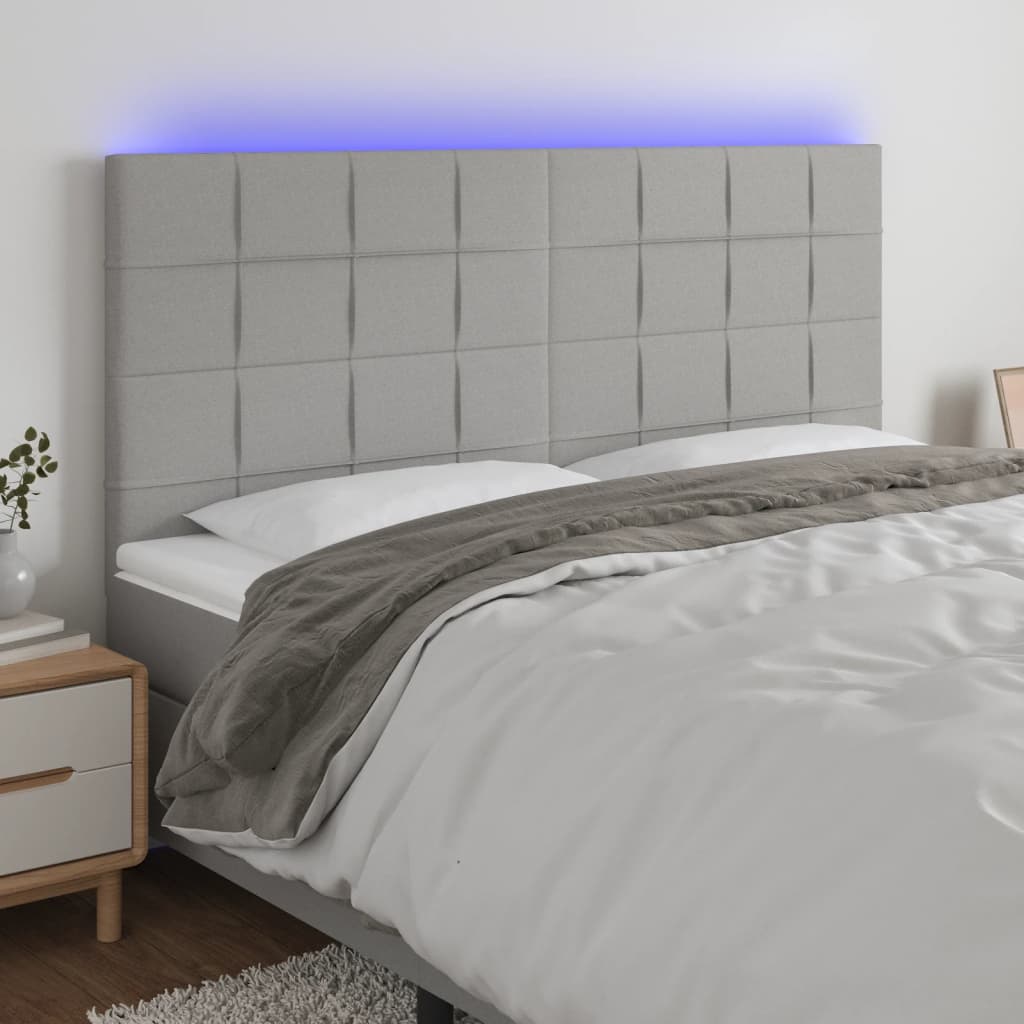 sengegavl med LED-lys 180x5x118/128 cm stof lysegrå