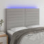 sengegavl med LED-lys 144x5x118/128 cm stof lysegrå