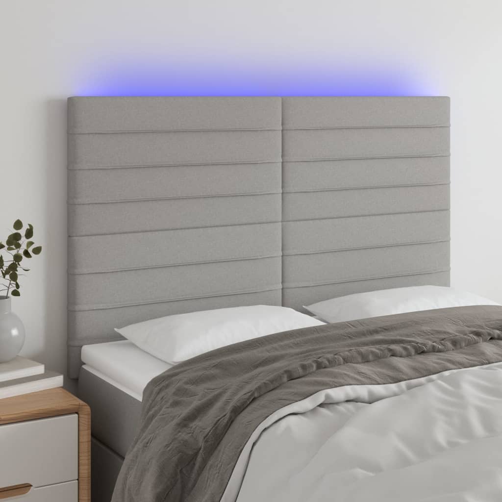 sengegavl med LED-lys 144x5x118/128 cm stof lysegrå