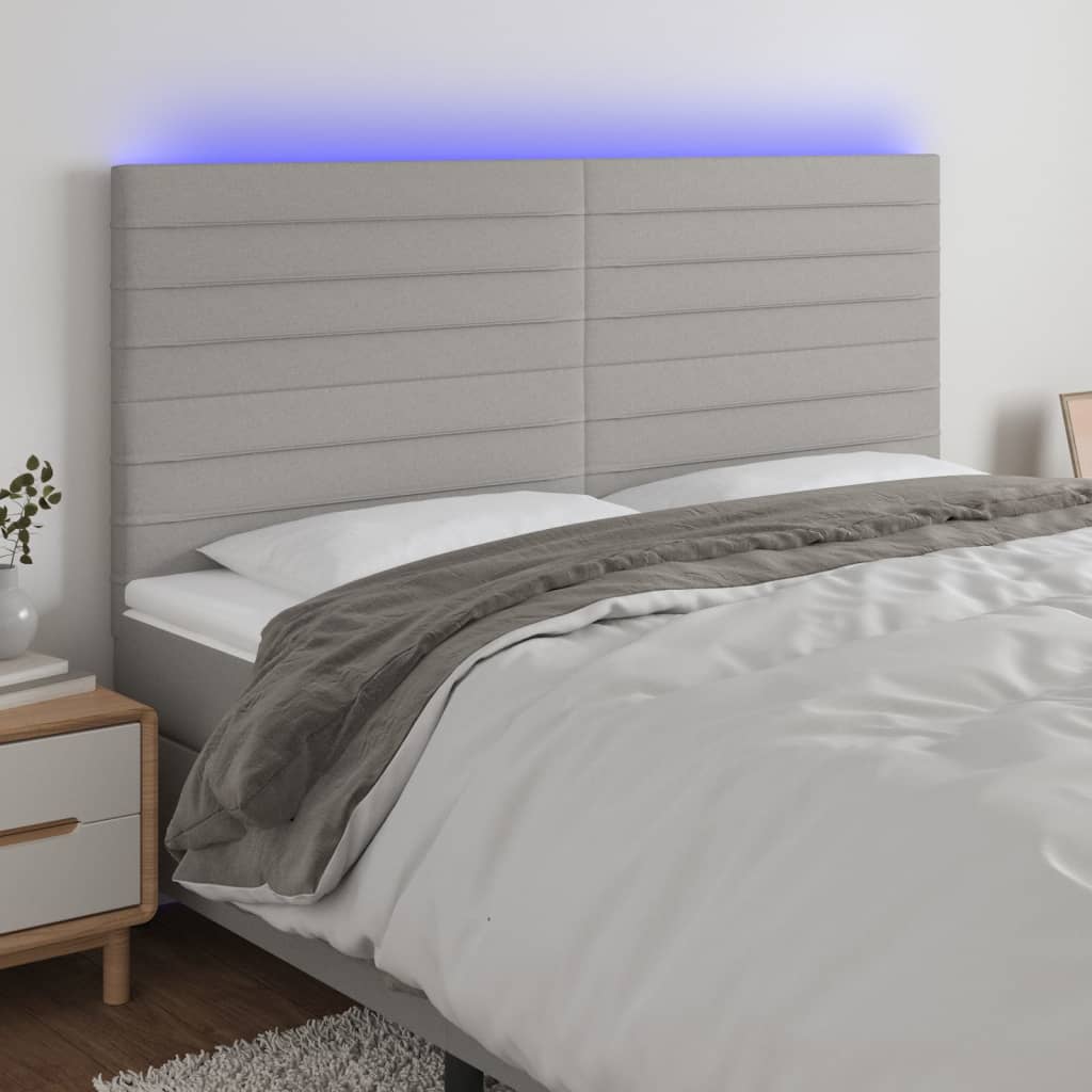 sengegavl med LED-lys 160x5x118/128 cm stof lysegrå
