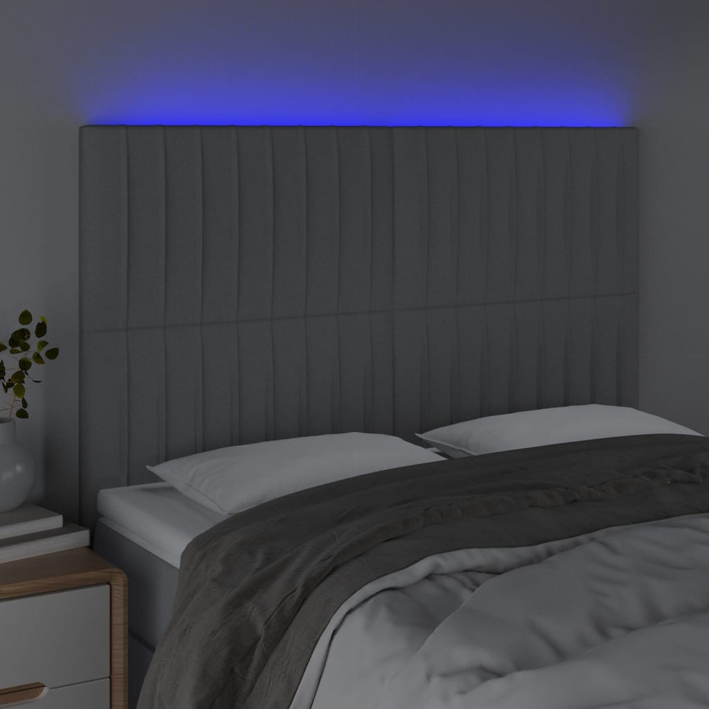 sengegavl med LED-lys 144x5x118/128 cm stof lysegrå