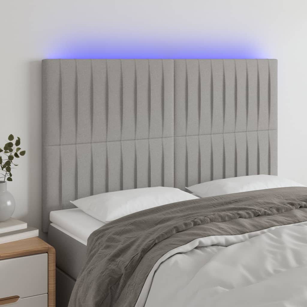 sengegavl med LED-lys 144x5x118/128 cm stof lysegrå