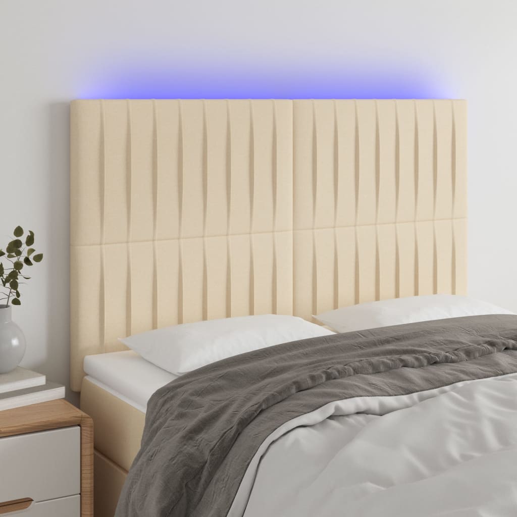sengegavl med LED-lys 144x5x118/128 cm stof cremefarvet