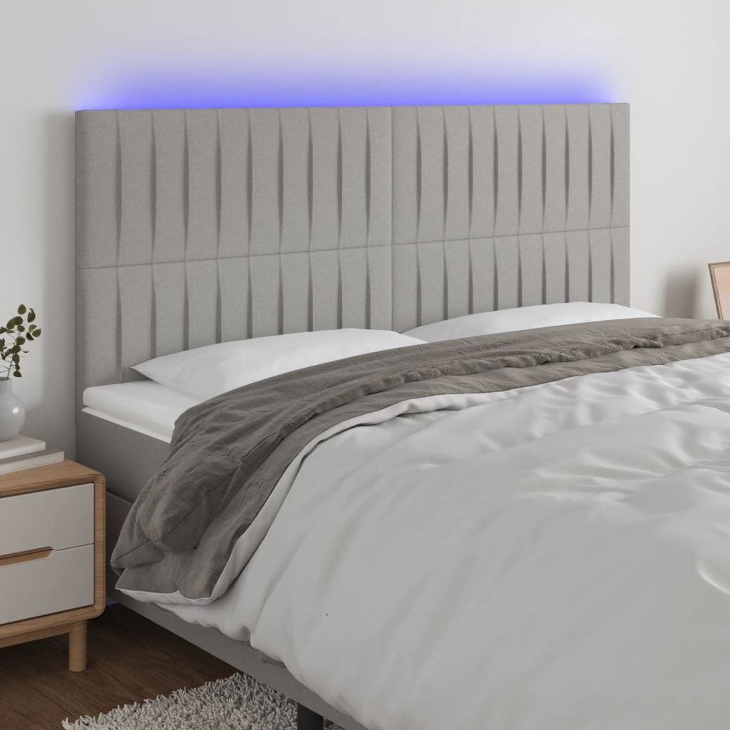 sengegavl med LED-lys 160x5x118/128 cm stof lysegrå