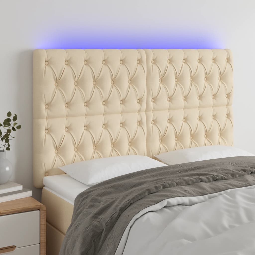 sengegavl med LED-lys 144x7x118/128 cm stof cremefarvet