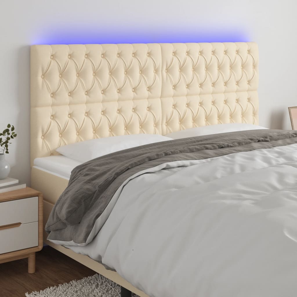 sengegavl med LED-lys 180x7x118/128 cm stof cremefarvet
