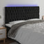 sengegavl med LED-lys 180x7x118/128 cm fløjl sort