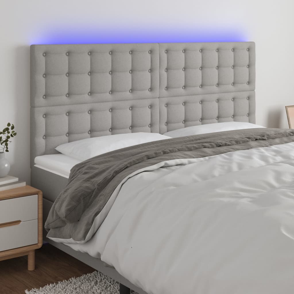 sengegavl med LED-lys 180x5x118/128 cm stof lysegrå