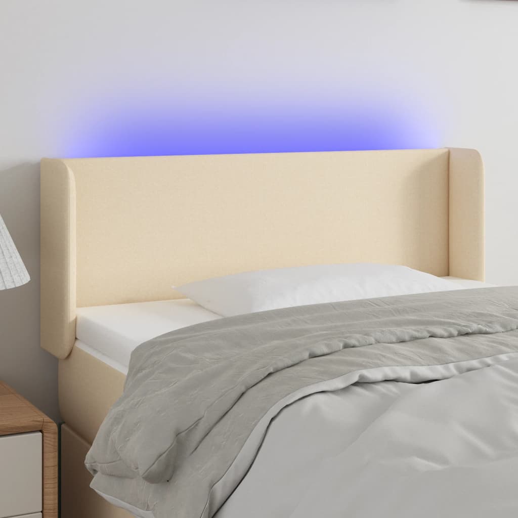 sengegavl med LED-lys 83x16x78/88 cm stof cremefarvet