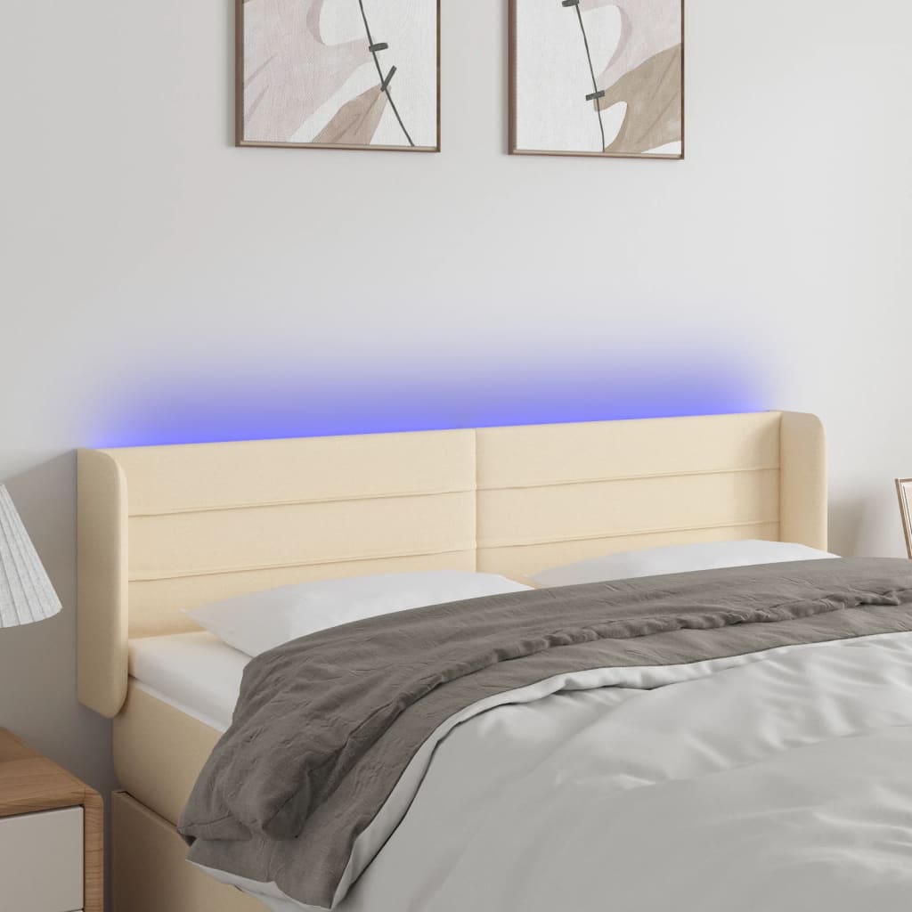 sengegavl med LED-lys 147x16x78/88 cm stof cremefarvet