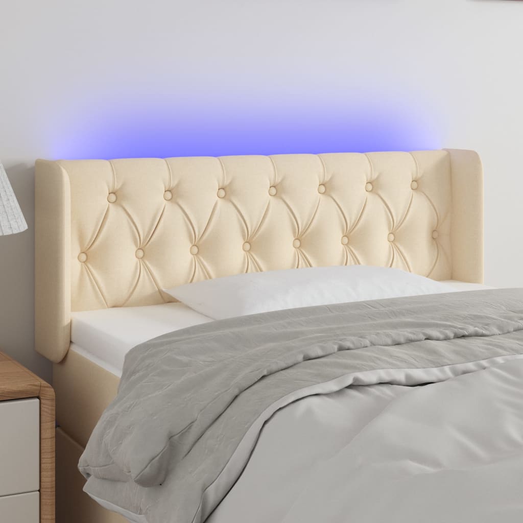 sengegavl med LED-lys 103x16x78/88 cm stof cremefarvet