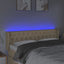 sengegavl med LED-lys 163x16x78/88 cm stof cremefarvet