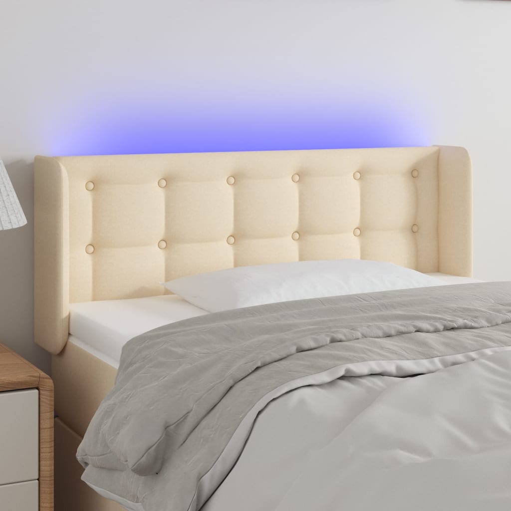 sengegavl med LED-lys 93x16x78/88 cm stof cremefarvet
