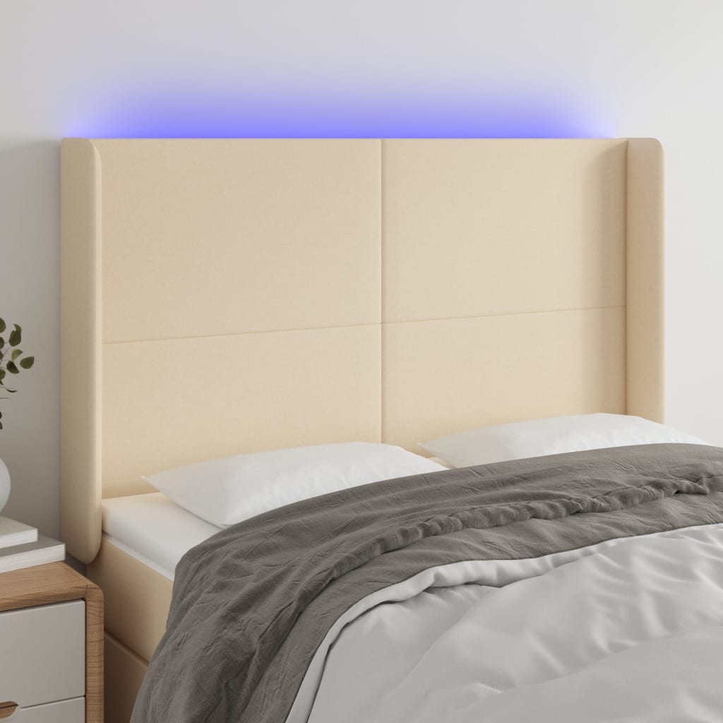 sengegavl med LED-lys 147x16x118/128 cm stof cremefarvet