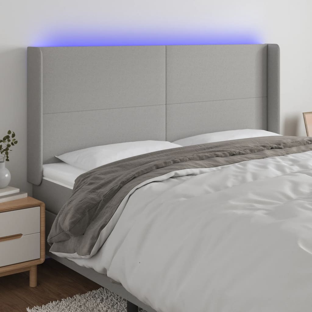 sengegavl med LED-lys 183x16x118/128 cm stof lysegrå