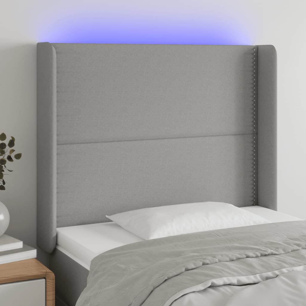 sengegavl med LED-lys 103x16x118/128 cm stof lysegrå