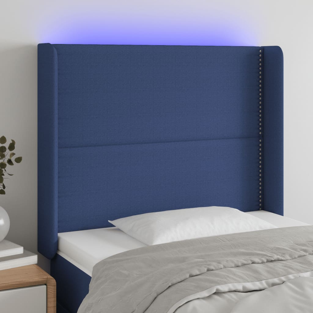 sengegavl med LED-lys 103x16x118/128 cm stof blå