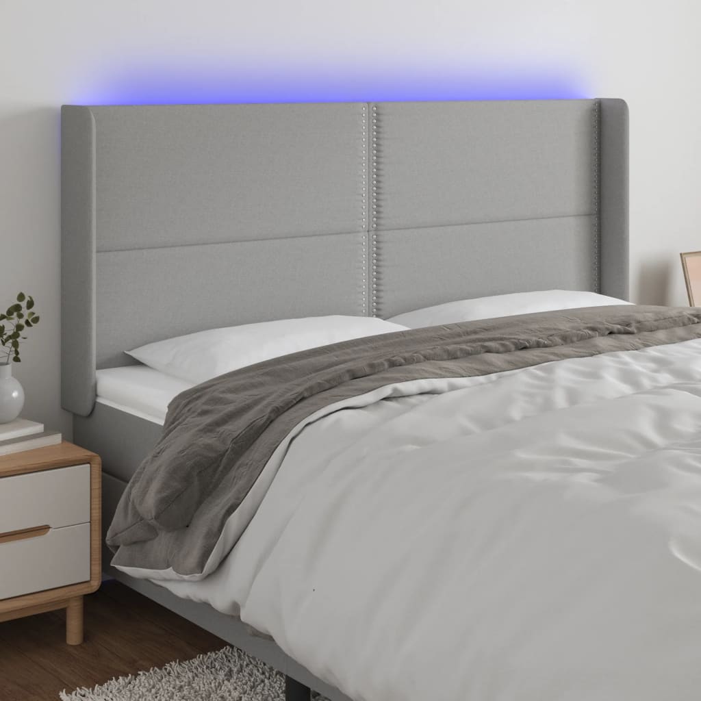 sengegavl med LED-lys 183x16x118/128 cm stof lysegrå