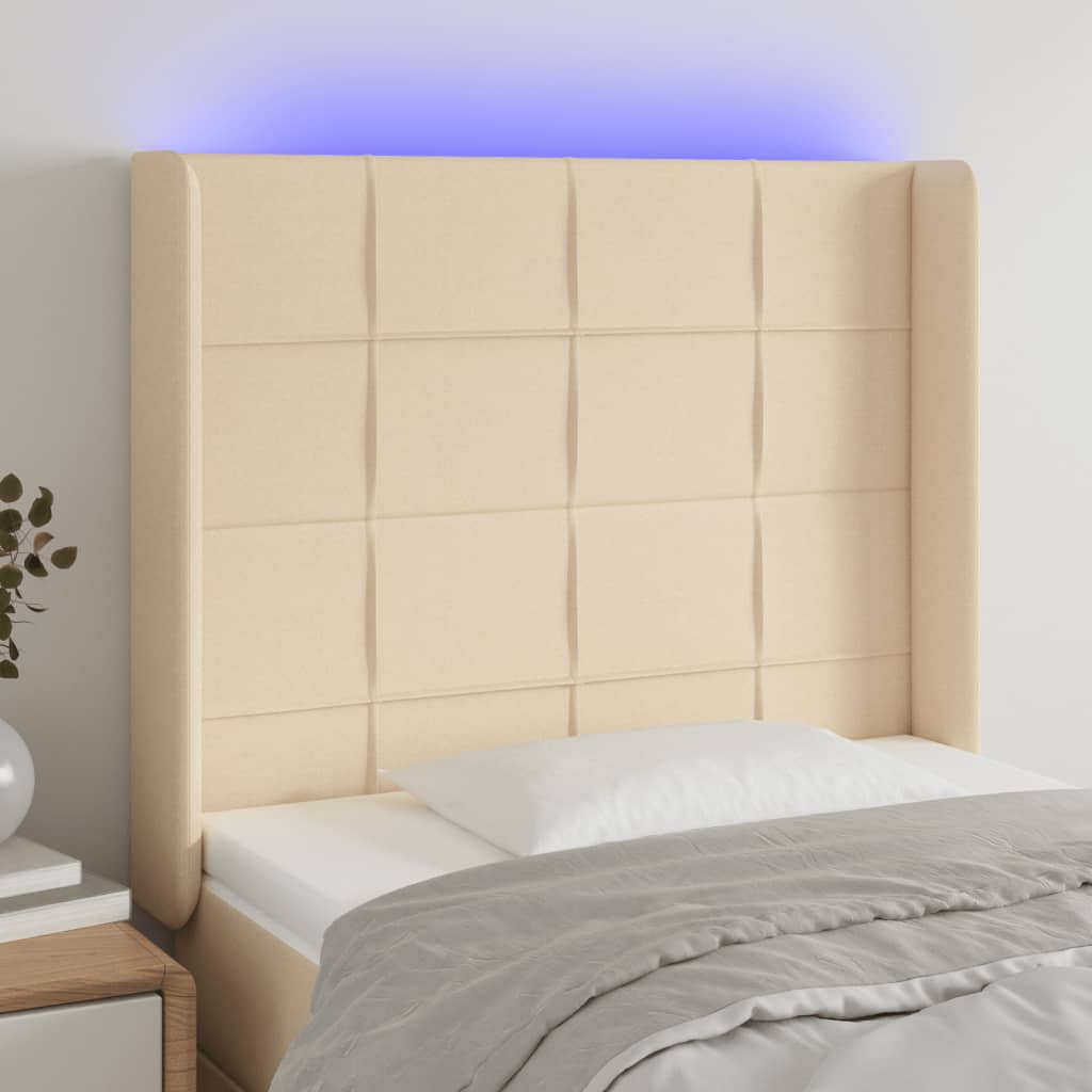 sengegavl med LED-lys 83x16x118/128 cm stof cremefarvet