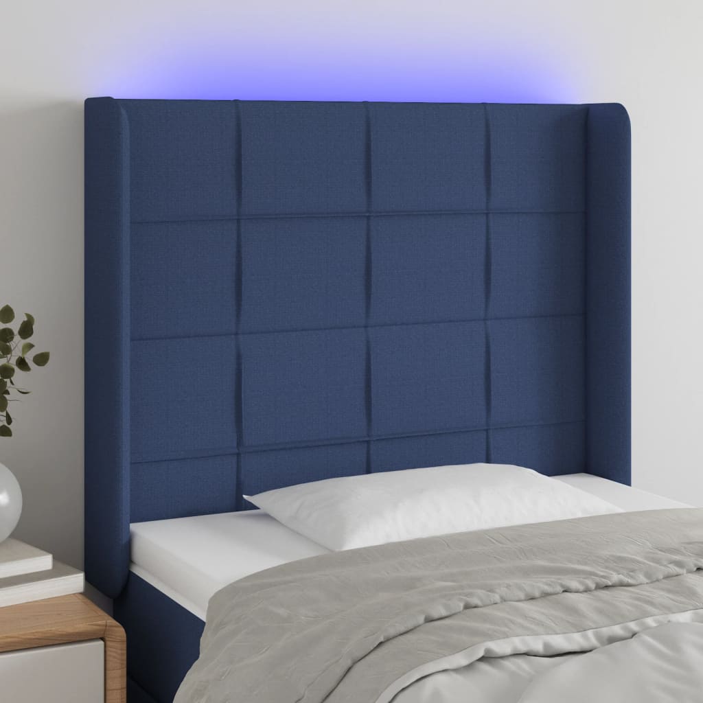 sengegavl med LED-lys 83x16x118/128 cm stof blå