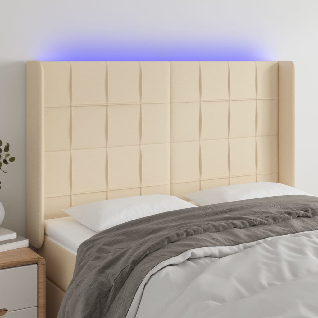 sengegavl med LED-lys 147x16x118/128 cm stof cremefarvet