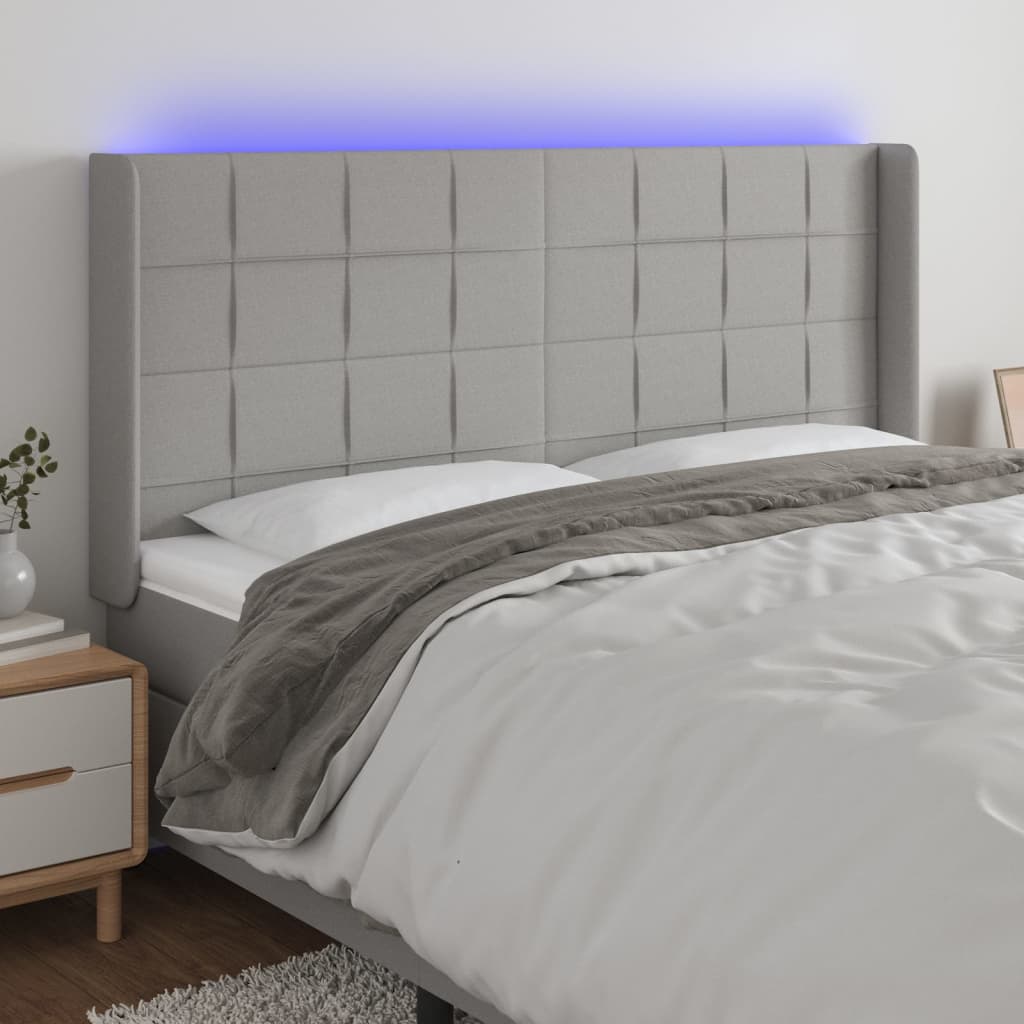 sengegavl med LED-lys 163x16x118/128 cm stof lysegrå