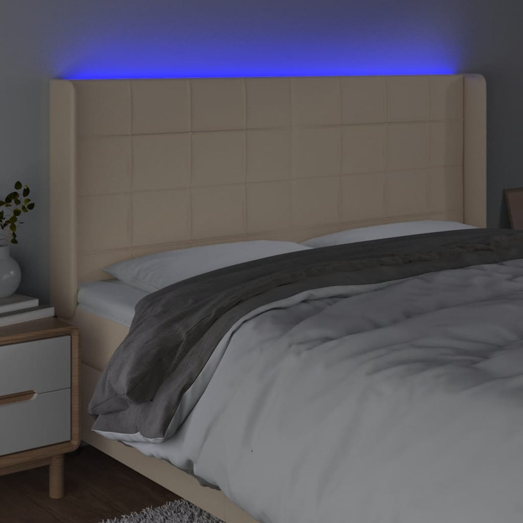 sengegavl med LED-lys 203x16x118/128 cm stof cremefarvet