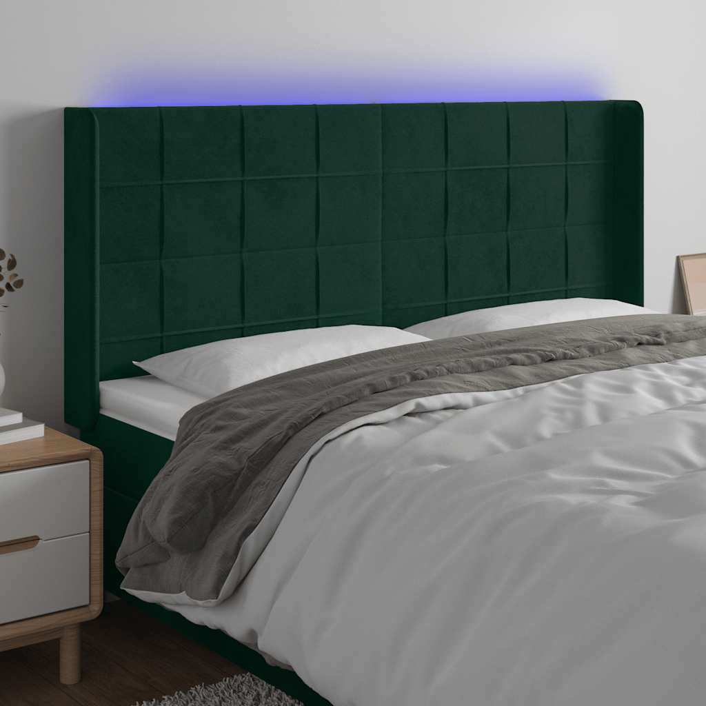 sengegavl med LED-lys 163x16x118/128 cm fløjl mørkegrøn