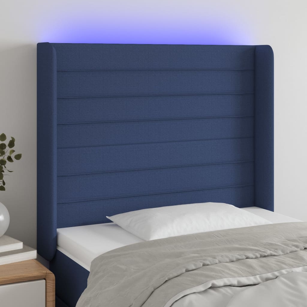 sengegavl med LED-lys 83x16x118/128 cm stof blå