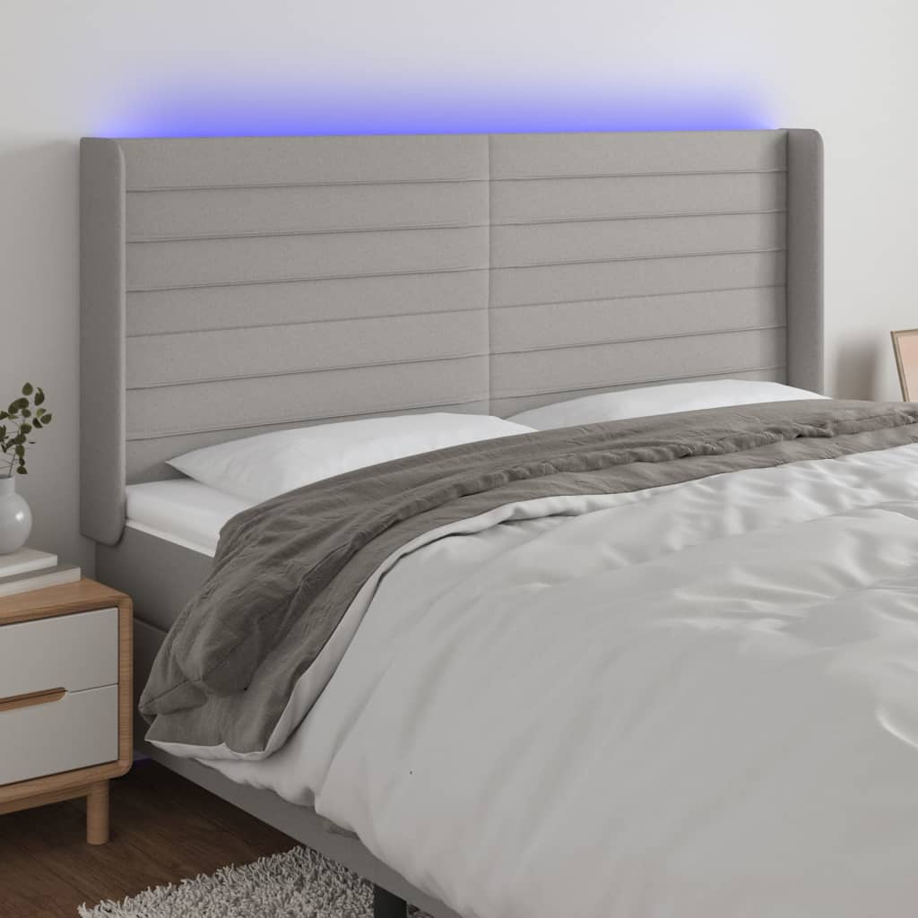 sengegavl med LED-lys 163x16x118/128 cm stof lysegrå