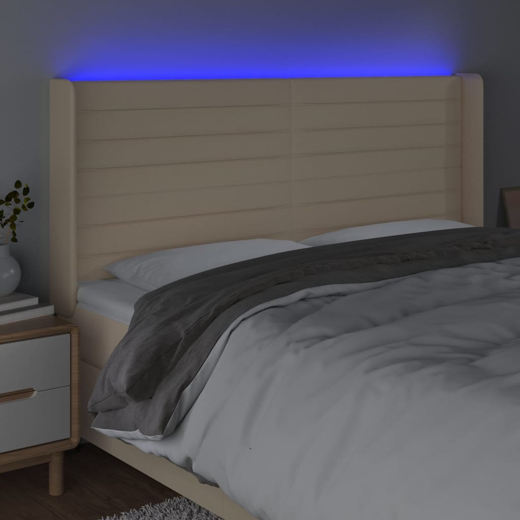 sengegavl med LED-lys 183x16x118/128 cm stof cremefarvet