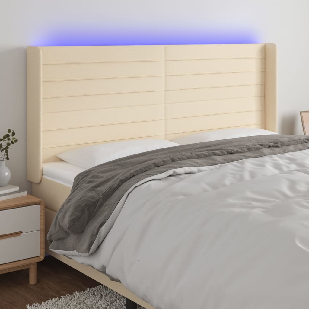 sengegavl med LED-lys 183x16x118/128 cm stof cremefarvet