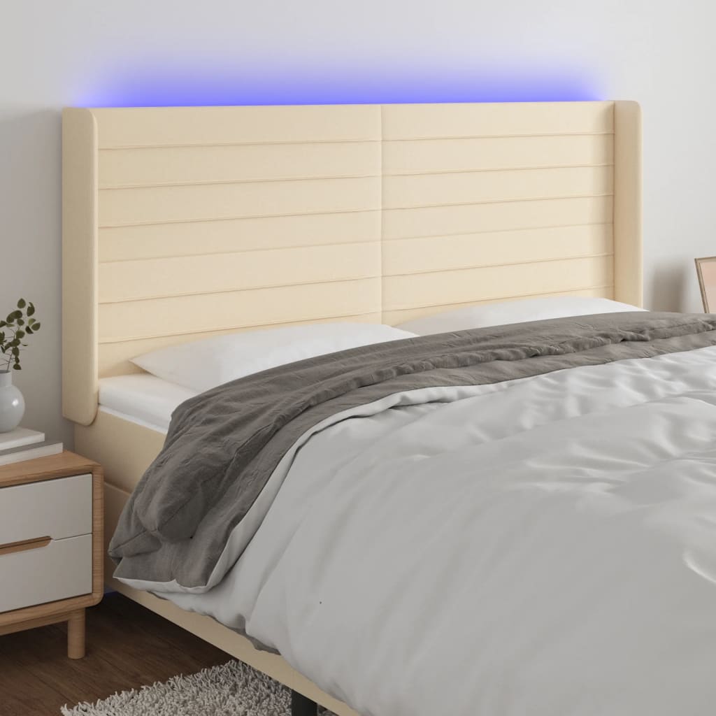 sengegavl med LED-lys 203x16x118/128 cm stof cremefarvet