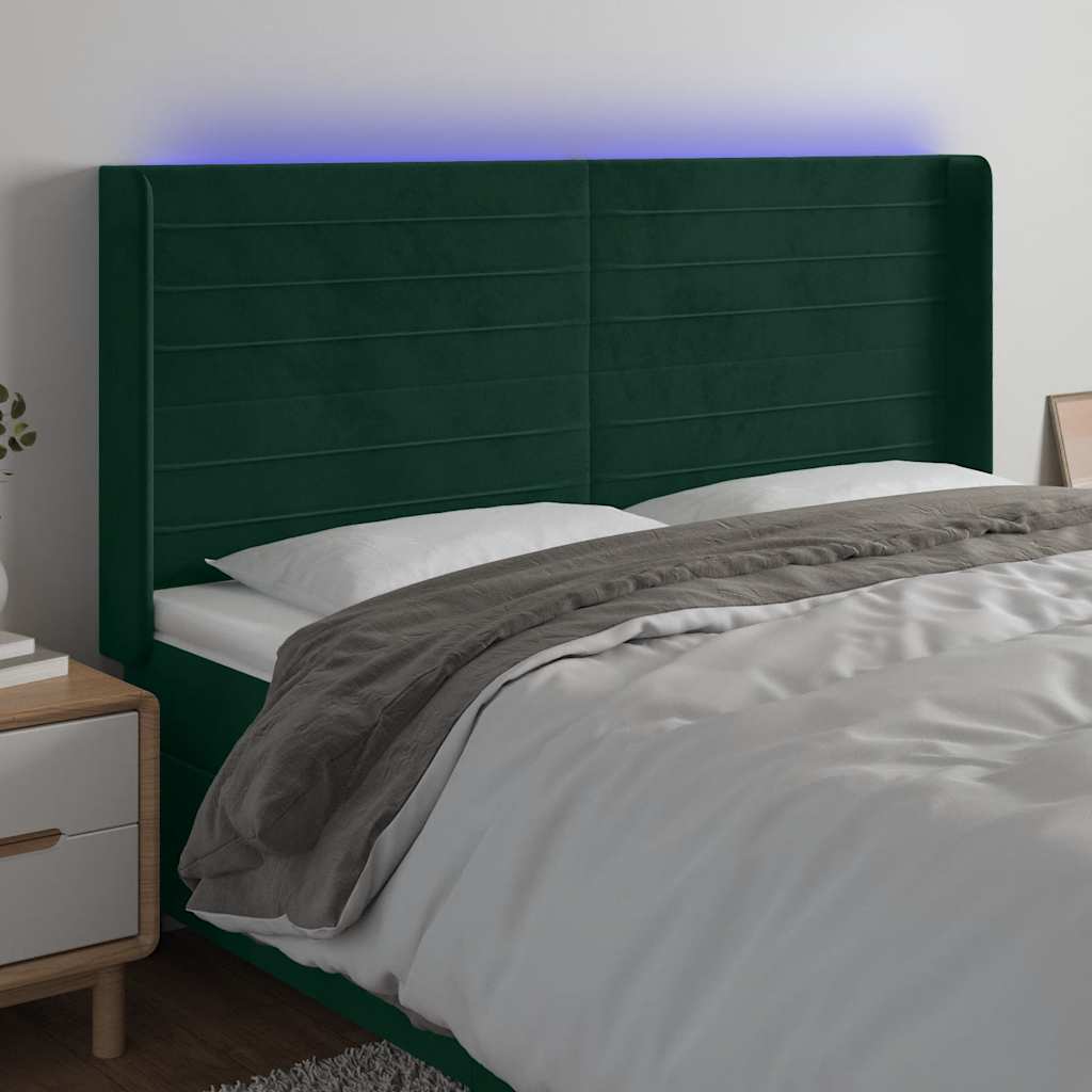 sengegavl med LED-lys 163x16x118/128 cm fløjl mørkegrøn