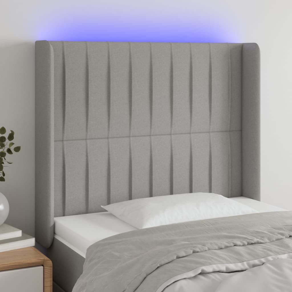 sengegavl med LED-lys 83x16x118/128 cm stof lysegrå