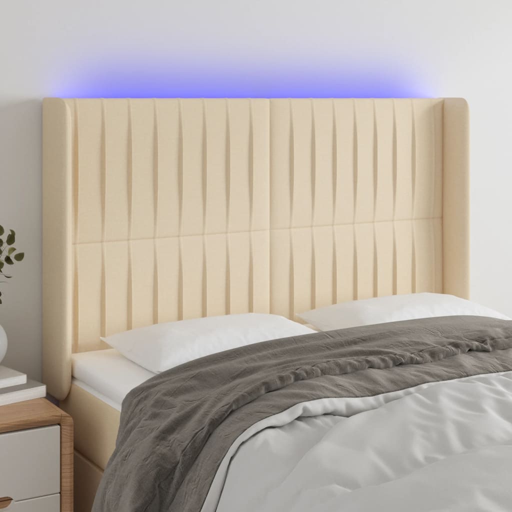sengegavl med LED-lys 147x16x118/128 cm stof cremefarvet
