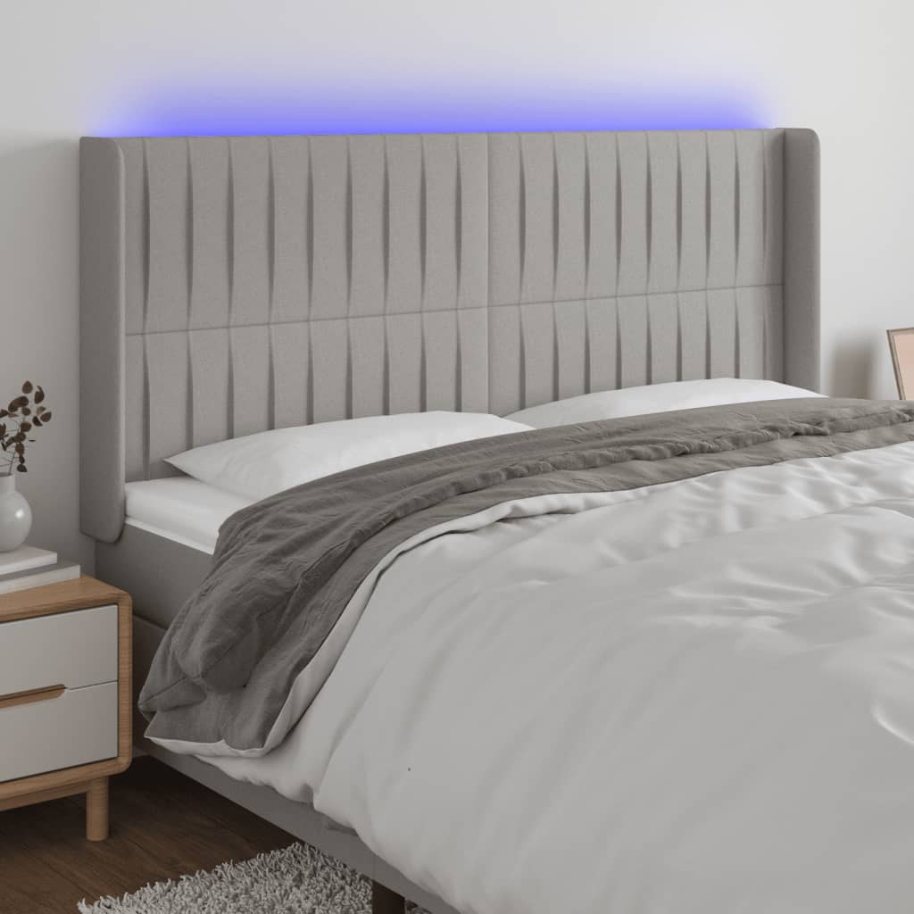 sengegavl med LED-lys 163x16x118/128 cm stof lysegrå