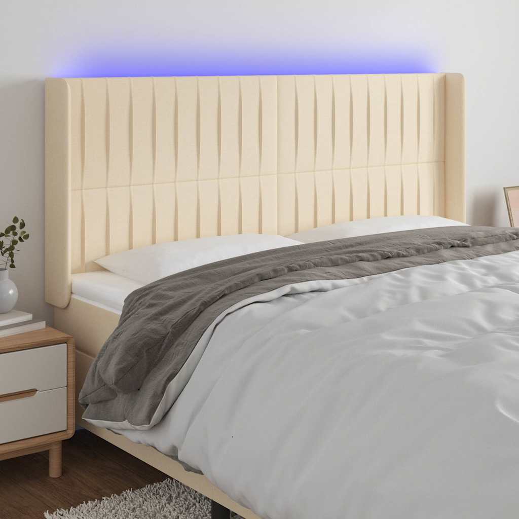 sengegavl med LED-lys 163x16x118/128 cm stof cremefarvet