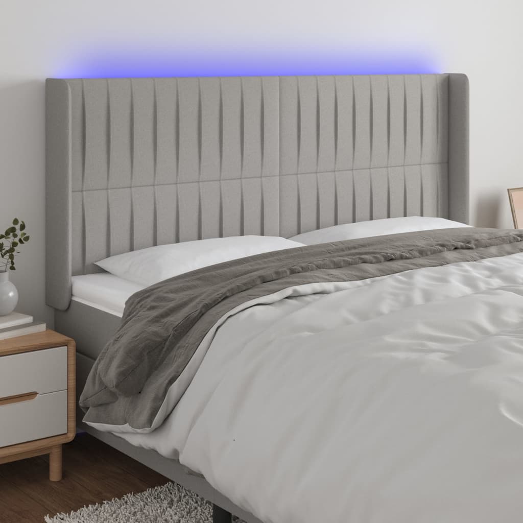 sengegavl med LED-lys 183x16x118/128 cm stof lysegrå