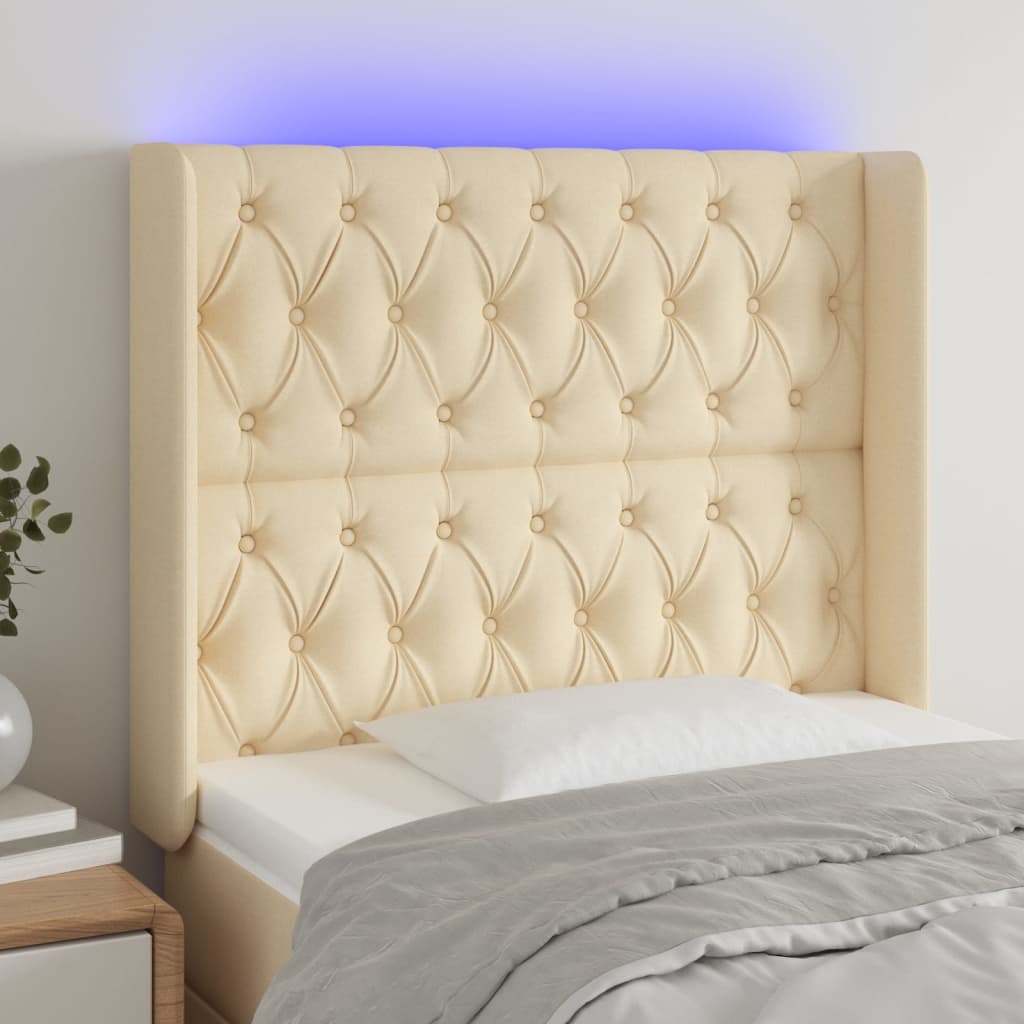 sengegavl med LED-lys 103x16x118/128 cm stof cremefarvet
