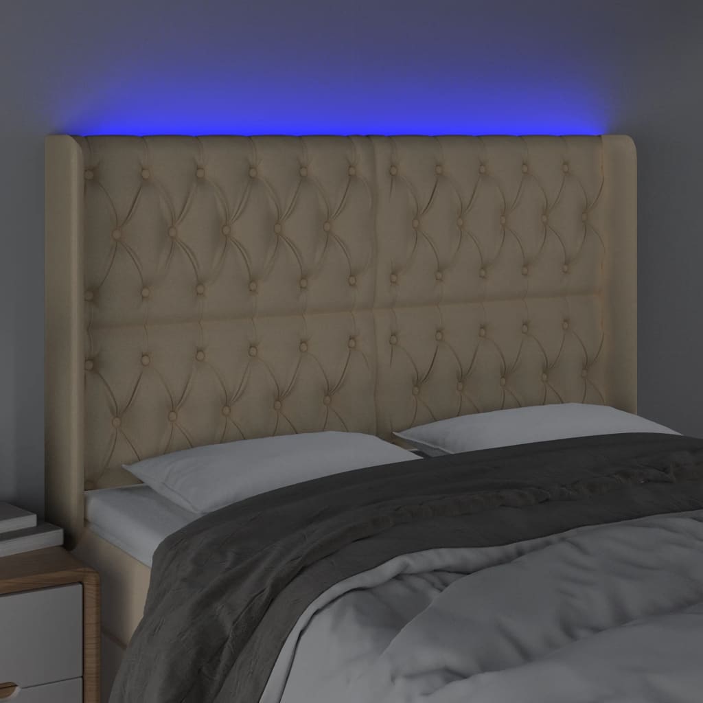 sengegavl med LED-lys 147x16x118/128 cm stof cremefarvet