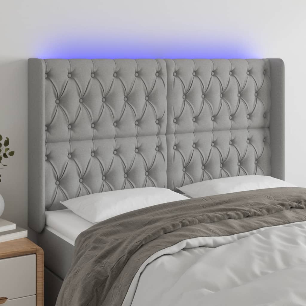 sengegavl med LED-lys 163x16x118/128 cm stof lysegrå